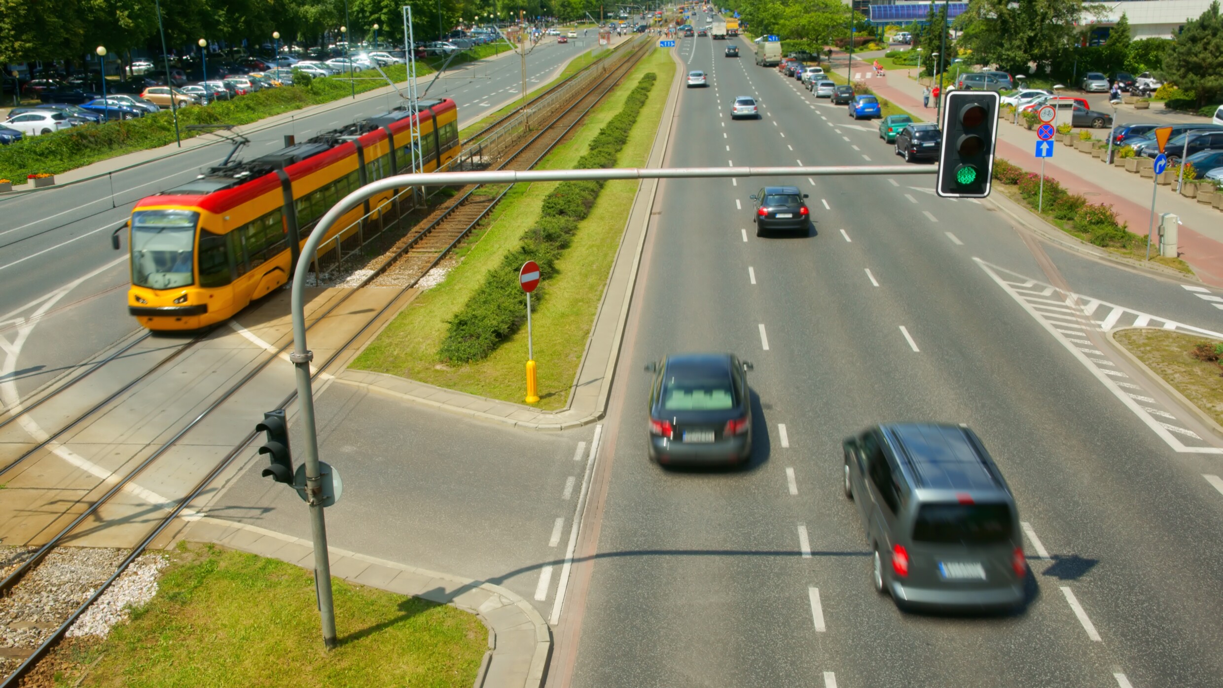 Big city traffic with cars, trams and traffic lights